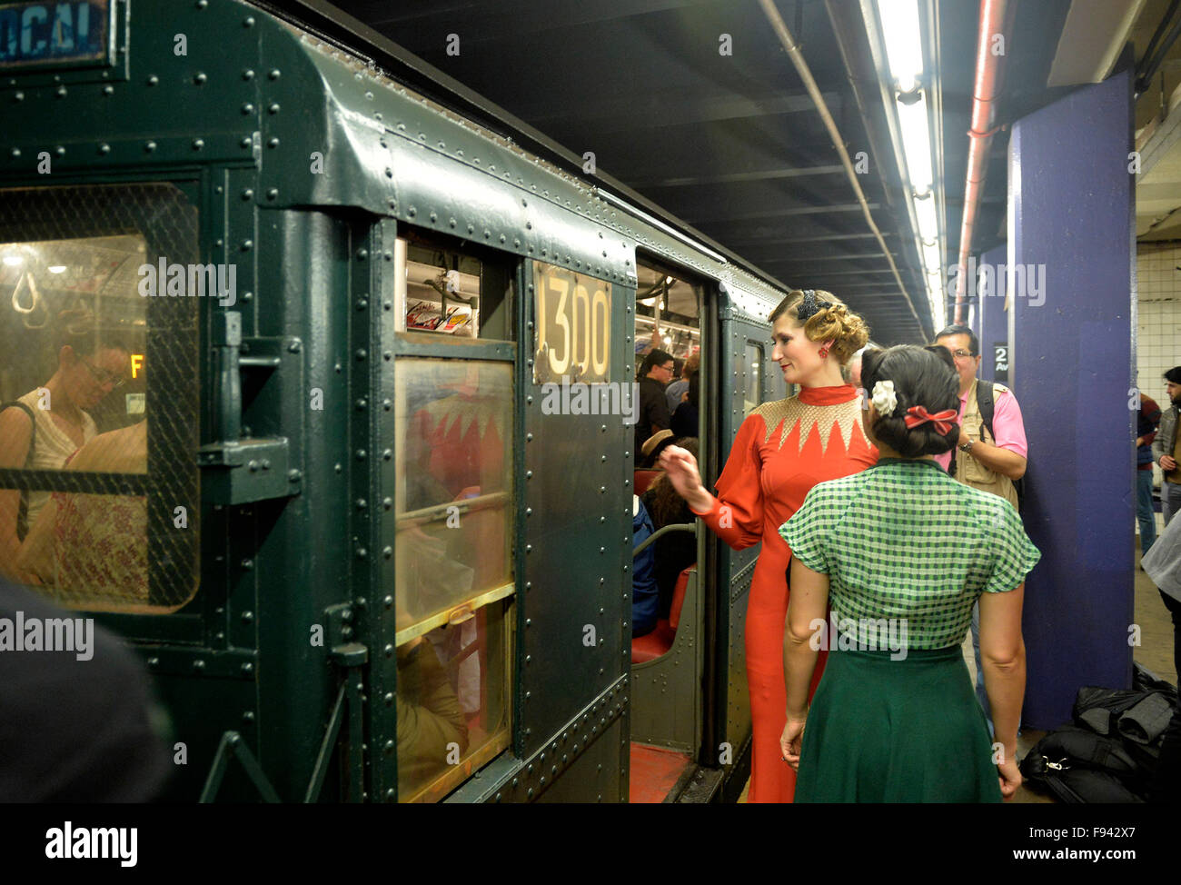 New York, USA. 13th Dec, 2015. Passengers experience antique cars at a subway station in New York City, the United States, Dec. 13, 2015. Starting on Dec. 6th and running for the following three Sundays, the MTA NYC runs the nostalgia train 'Shoppers Special,' which boasts eight cars running from the 1930s to the 1970s. © Wang Lei/Xinhua/Alamy Live News Stock Photo