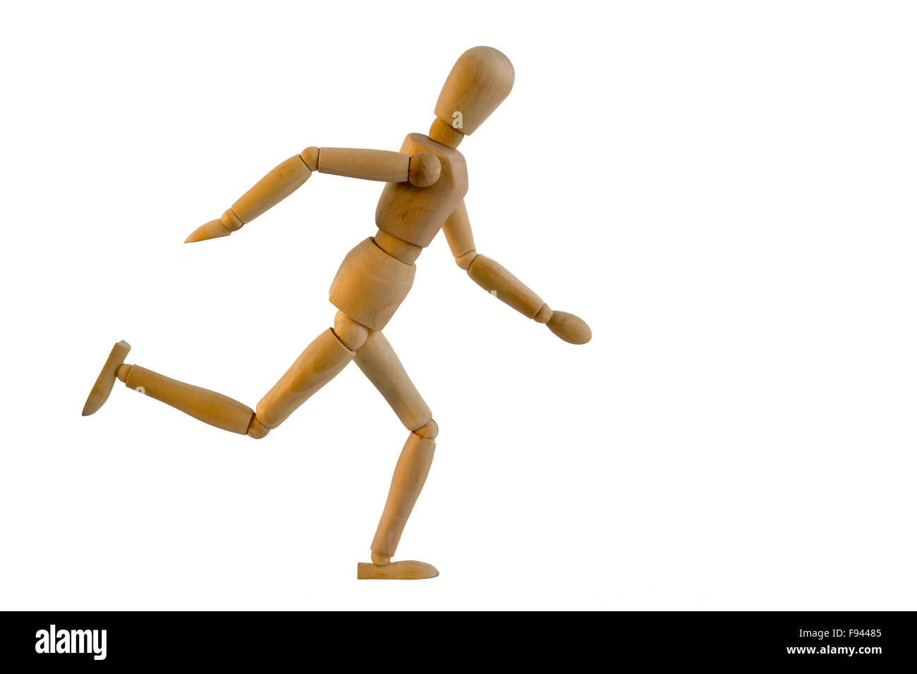 Wooden puppet is running on white Stock Photo