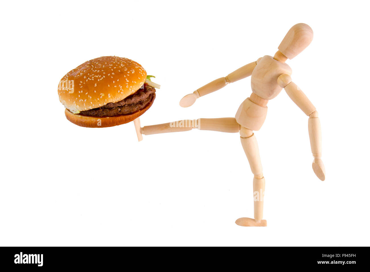 Puppet kicks burger away on white background Stock Photo