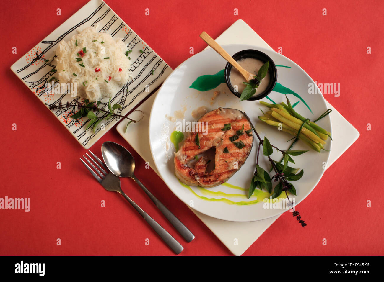 Grilled salmon steak, ginger & basil flower coconut infused sauce, rice