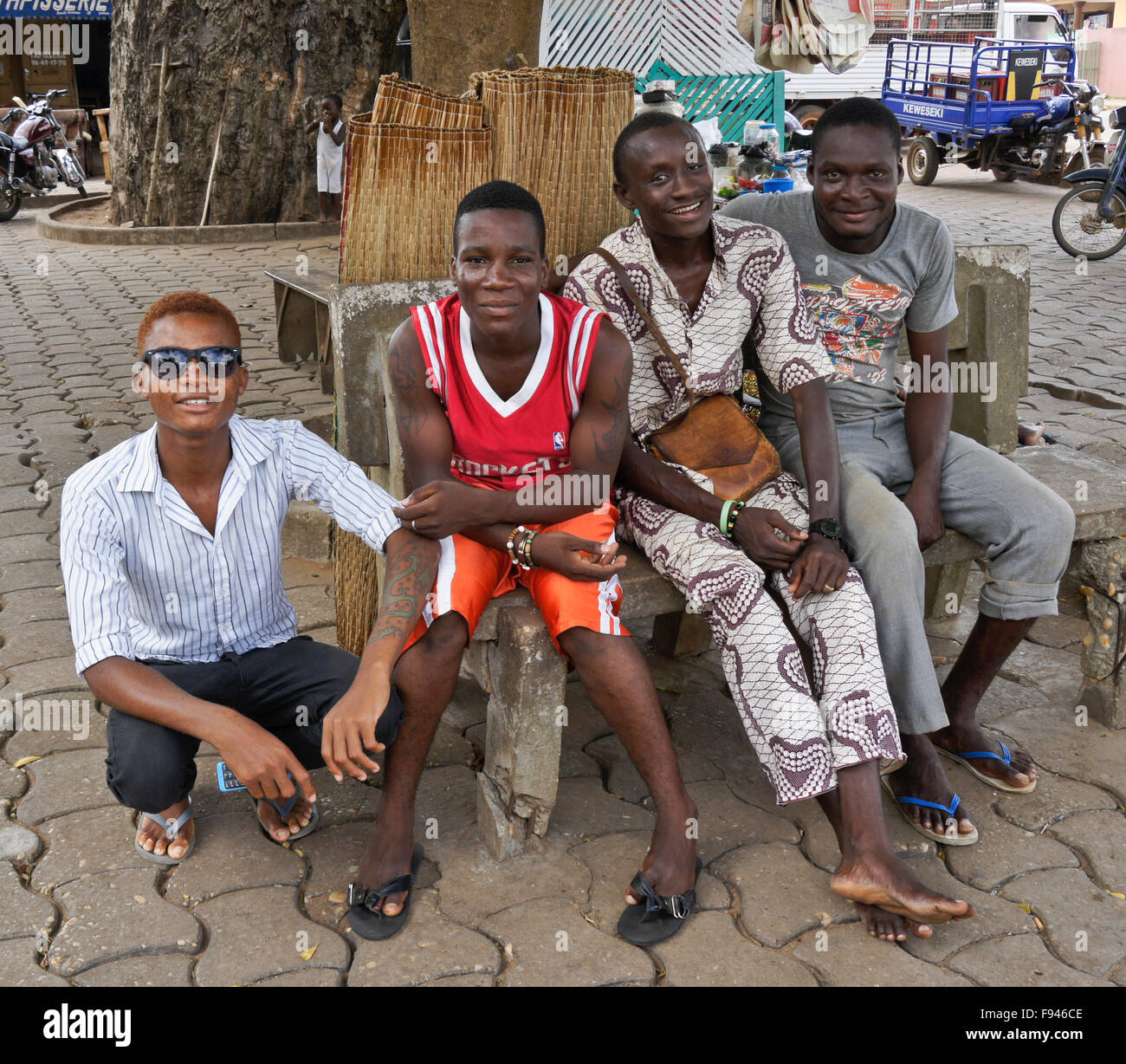 Group of men sitting outdoors, Ouidah, Benin Stock Photo
