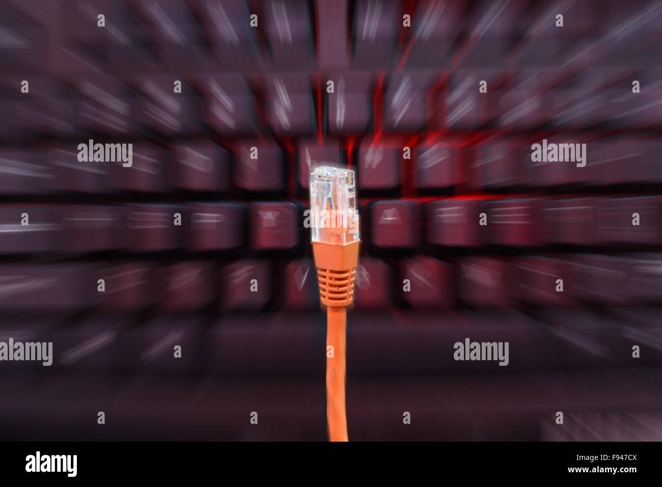 Internet cable in front of blurry keyboard with zoom Stock Photo