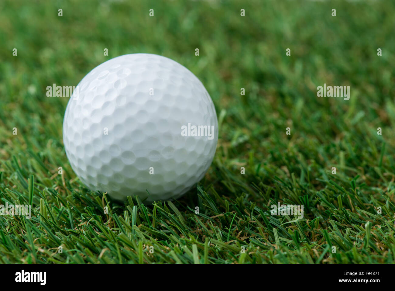 golf ball on green field Stock Photo Alamy