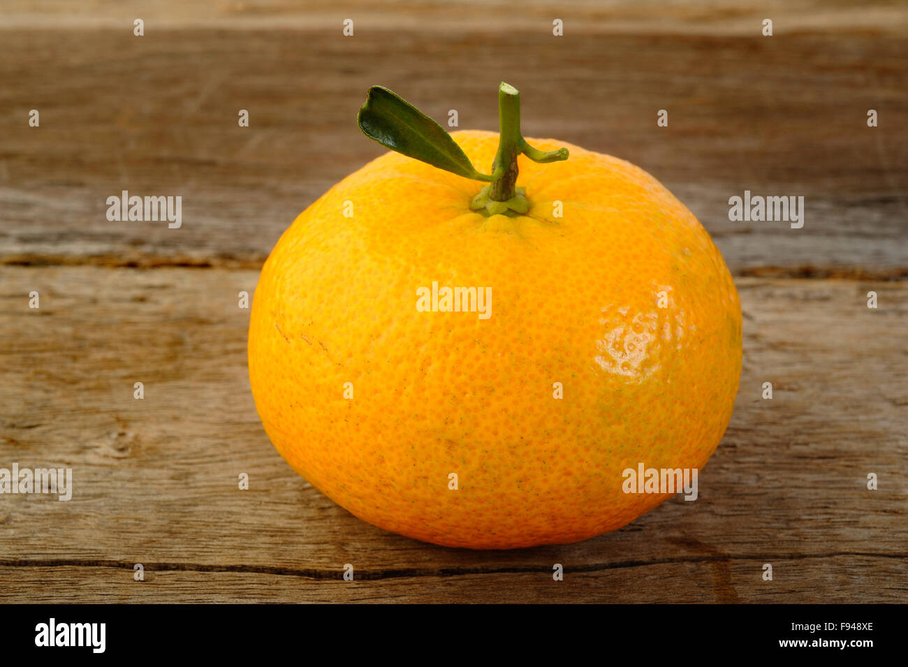 Ripe mandarin fruit on rustic wooden background Stock Photo