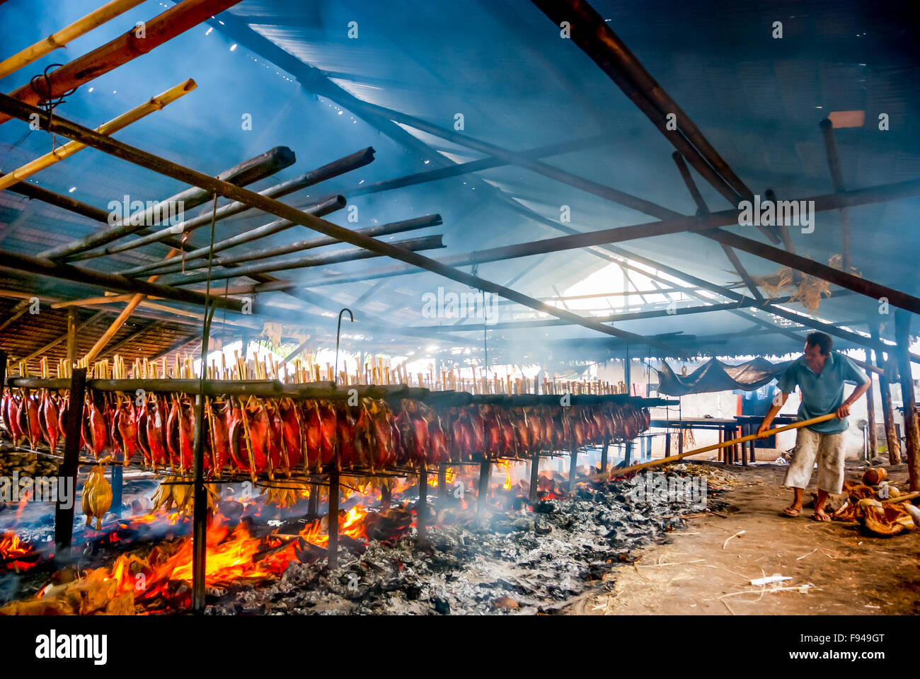 A Worker Smoking Tuna Fishes At An Industrial Food Preservation In a-worker-smoking-tuna-fishes-at-an-industrial-food-preservation-in