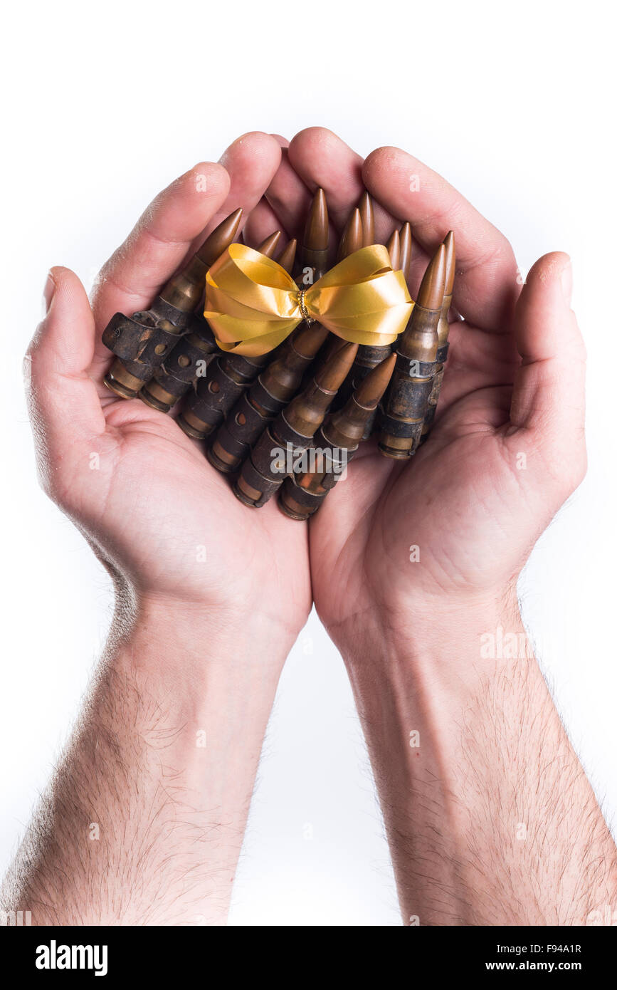 Concept hands giving bullets on white background Stock Photo - Alamy