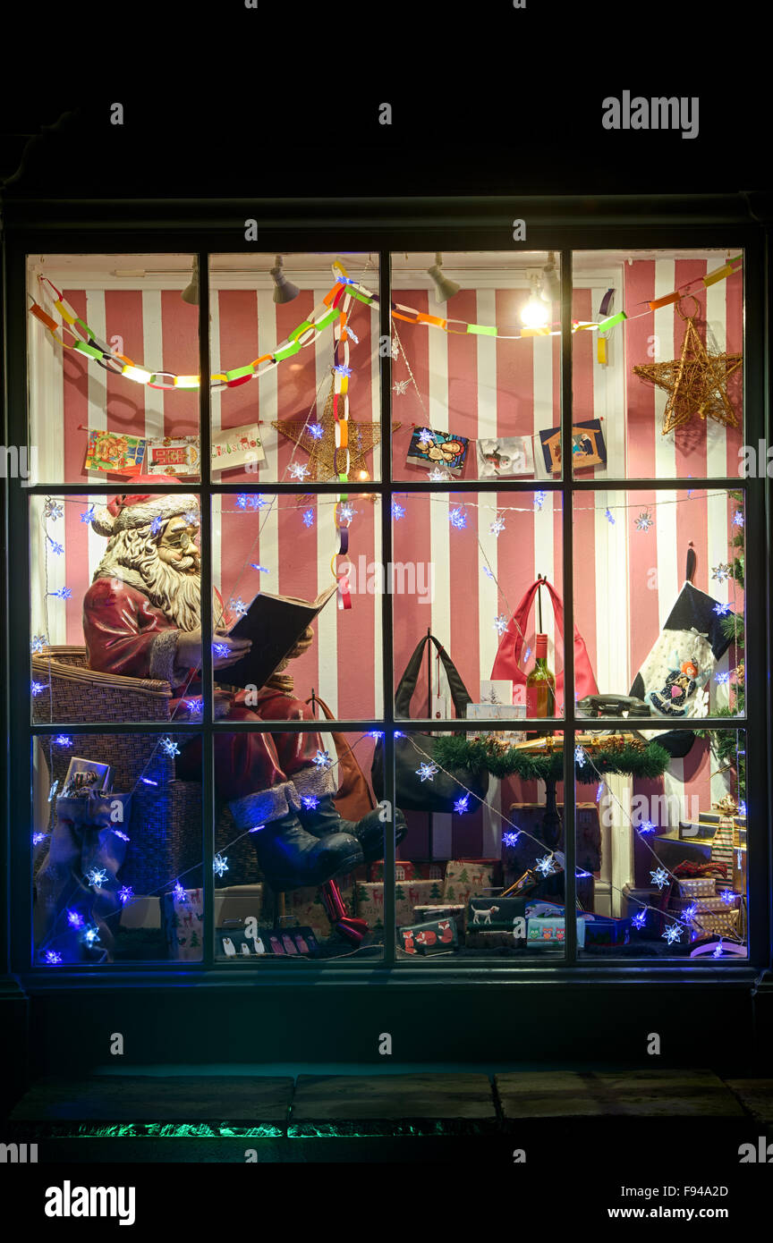 Christmas Santa display in a shop window at Bourton on the Water, Cotswolds, Gloucestershire, England Stock Photo