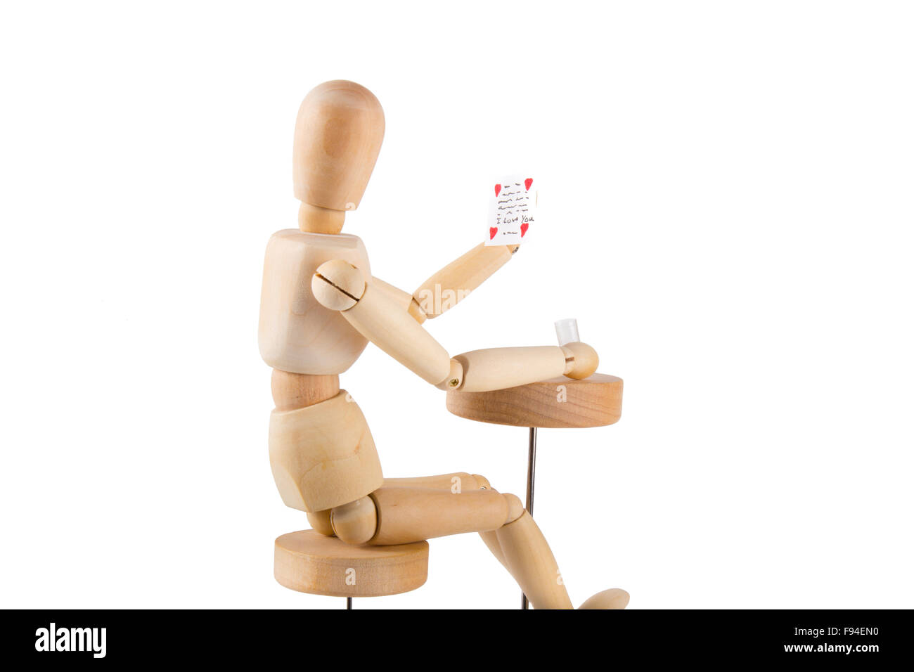 Puppet reading a love letter and having a drink on white background Stock Photo