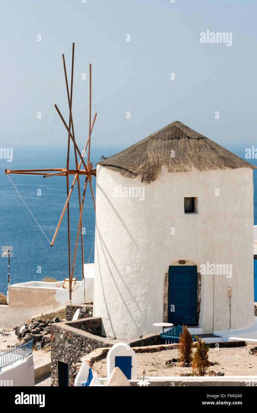 Cyclades, Santorini. Typical Greek round whitewashed windmill with thatched  roof, against summer clear blue sky and sea Stock Photo - Alamy
