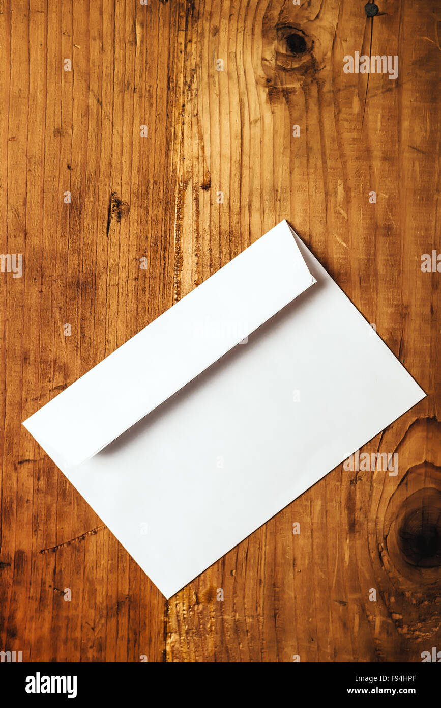 Blank white mailing envelope on office desk, copy space, top view Stock Photo