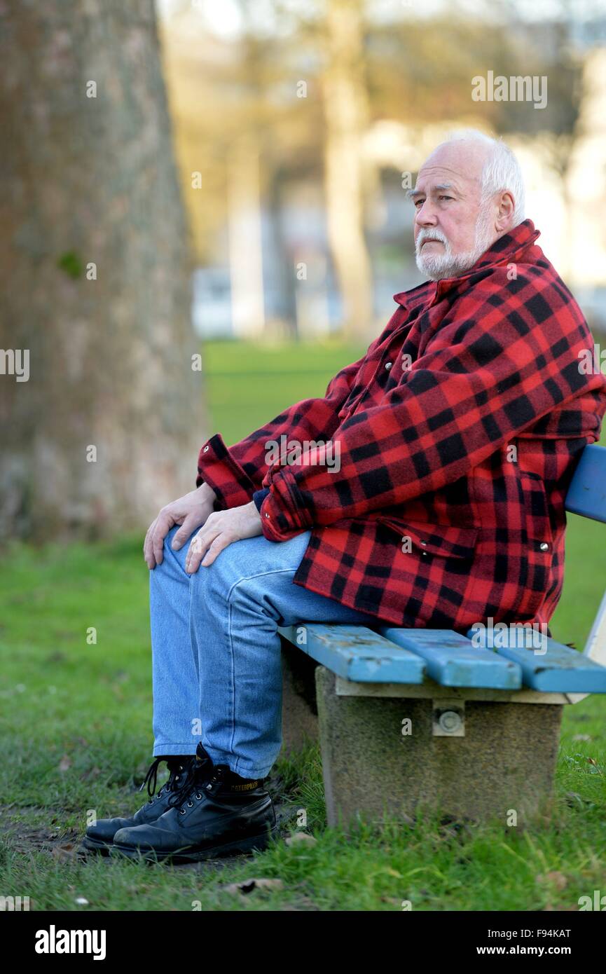 Elderly man sitting on a bank thinking, Germany, city of Osterode, 10. December 2015. Photo: Frank May Stock Photo