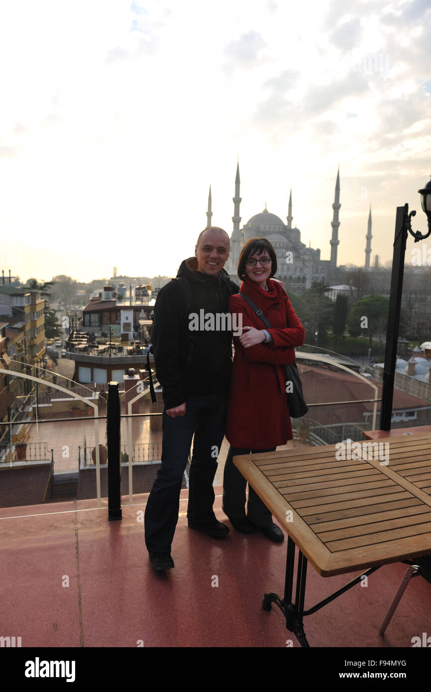 happy young couple portrait outdoor at sunny day in istanbul turkey with beautiful old mosque with sunset in background Stock Photo