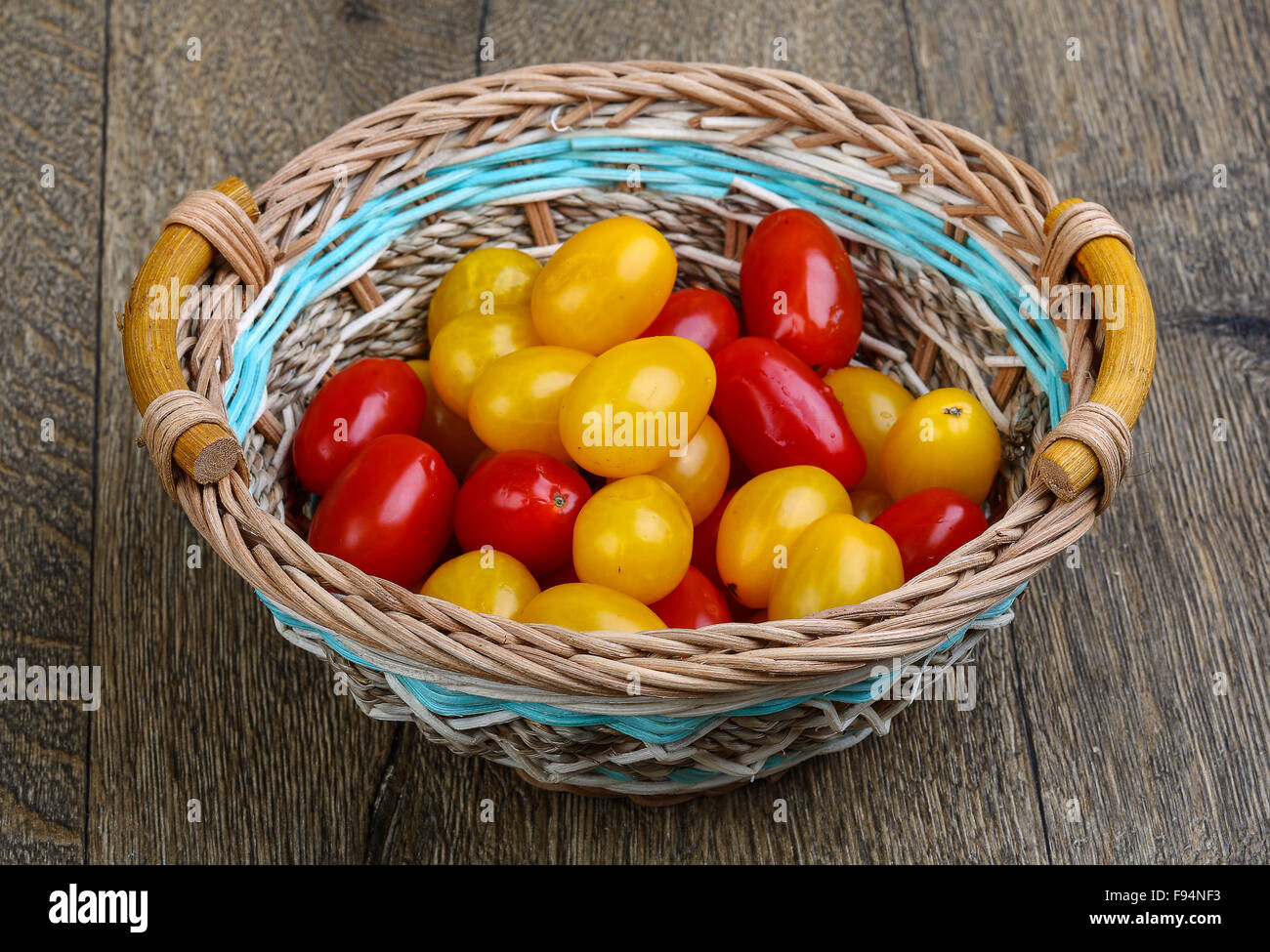 Yellow and red cherry tomatoes mix on the basket Stock Photo - Alamy