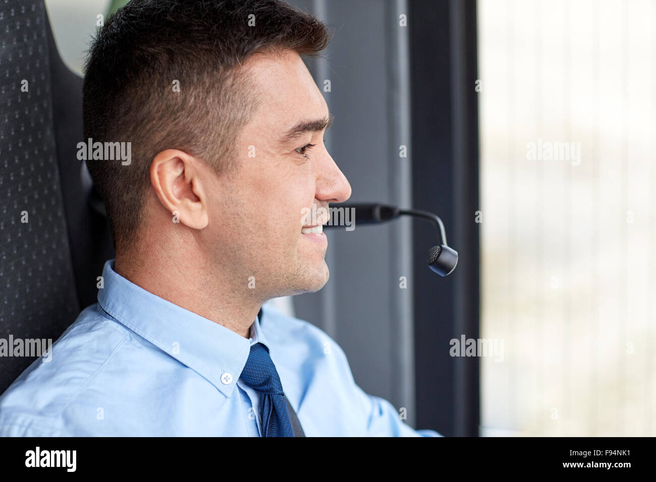happy bus driver face with microphone Stock Photo