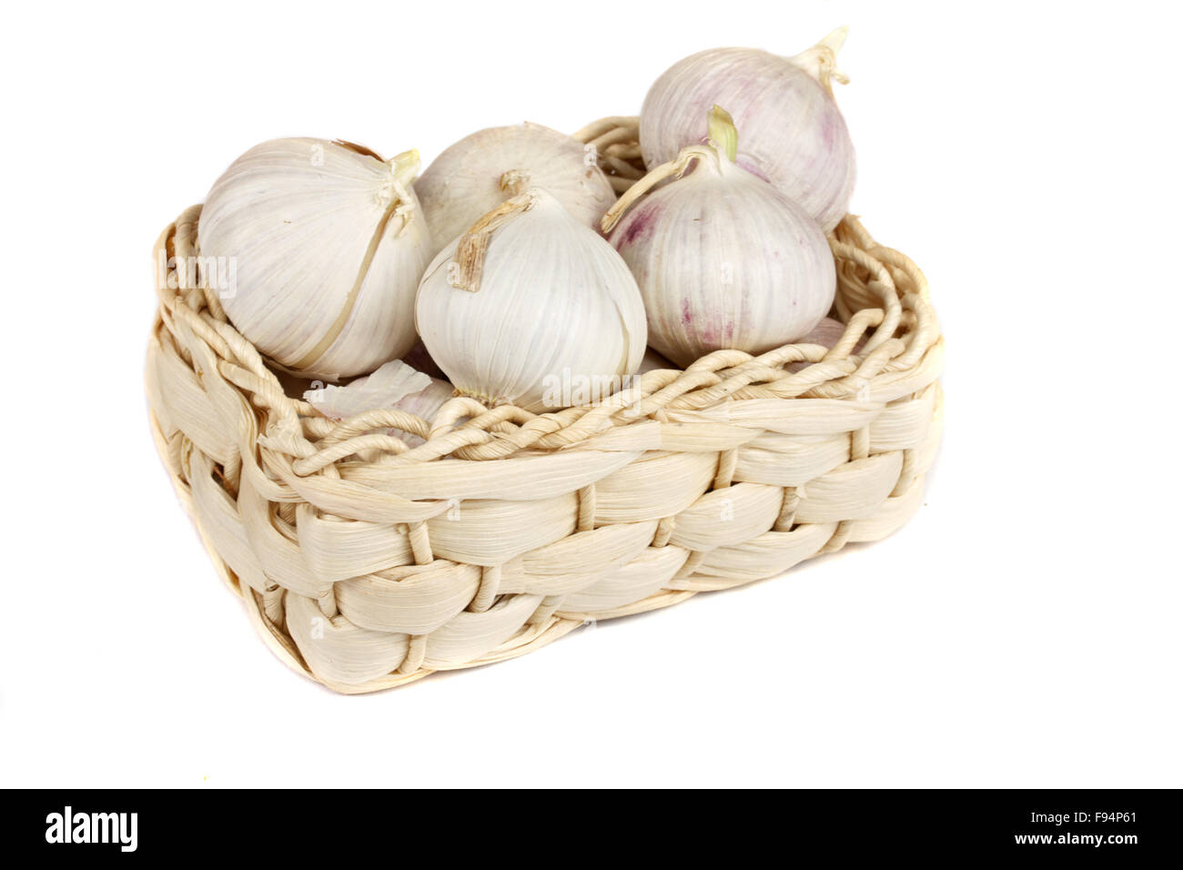 Several garlic onions in a basket isolated over white Stock Photo - Alamy