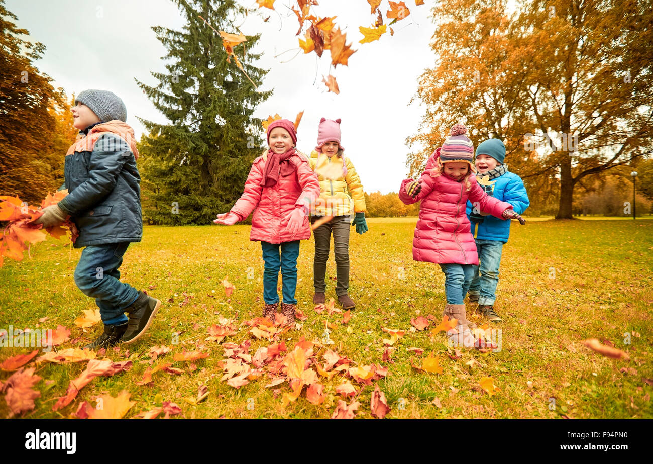 happy children playing with autumn leaves in park Stock Photo - Alamy