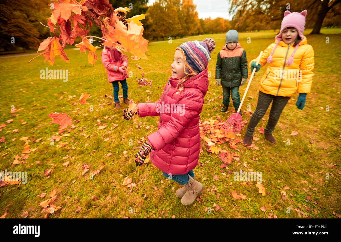 happy children playing with autumn leaves in park Stock Photo - Alamy