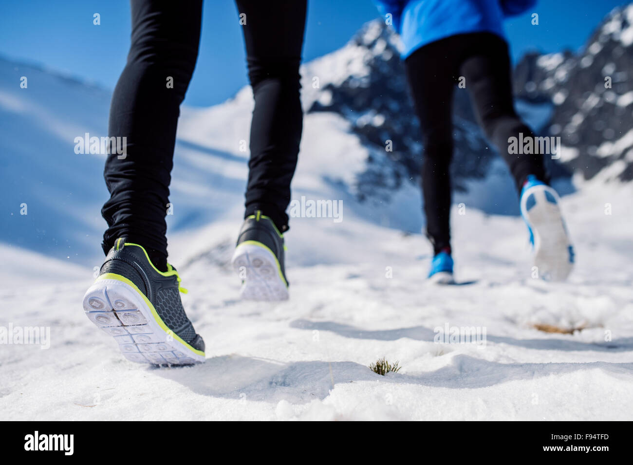 Legs of two runners outside in winter nature Stock Photo