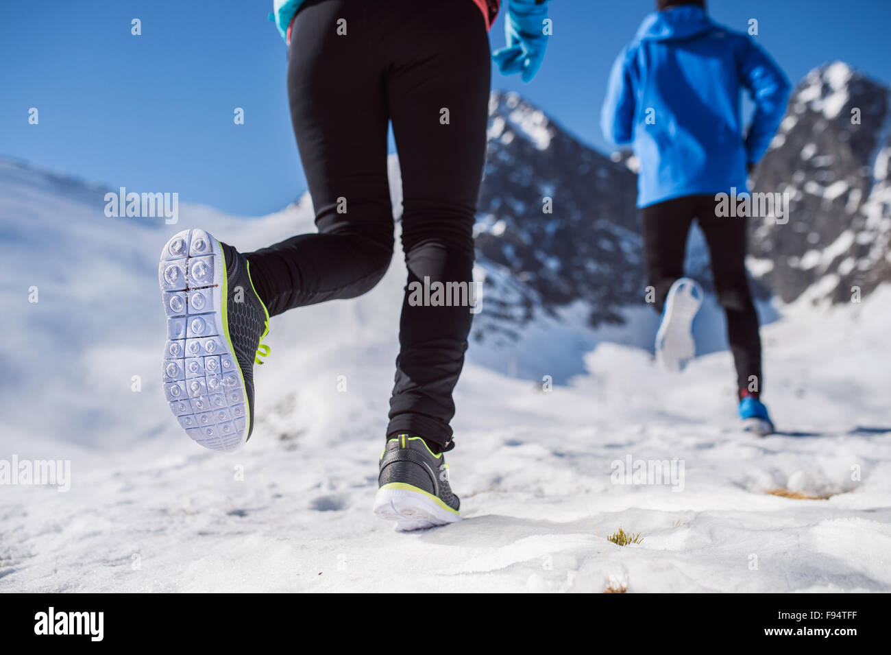 Legs of two runners outside in winter nature Stock Photo