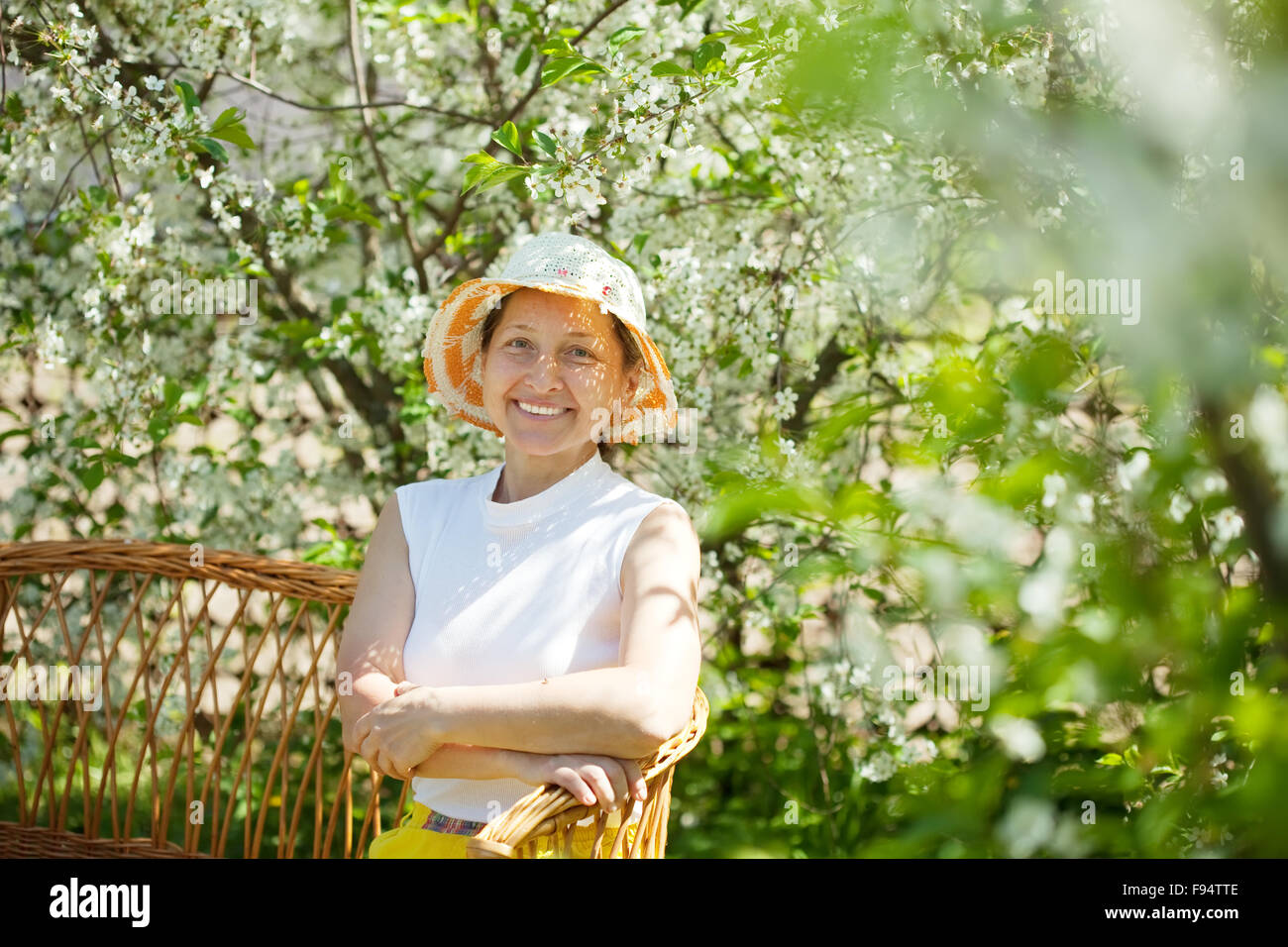 Happy mature woman relaxing in bloom garden Stock Photo - Alamy