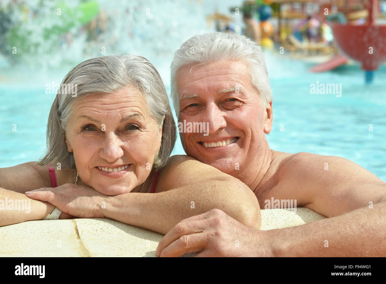 Senior couple relaxing at pool Stock Photo - Alamy