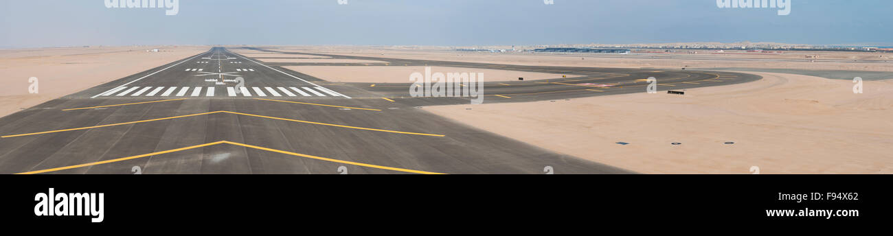 Aerial panoramic view of a commercial airport runway with connections and taxiways Stock Photo