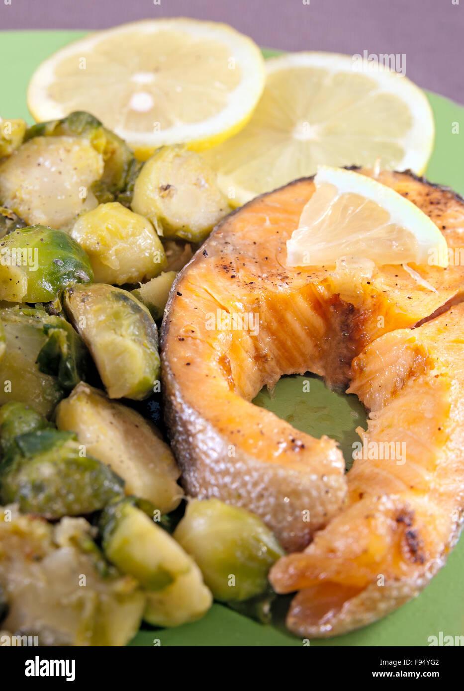 Steak of a trout with roasted brussels sprouts and lemon Stock Photo