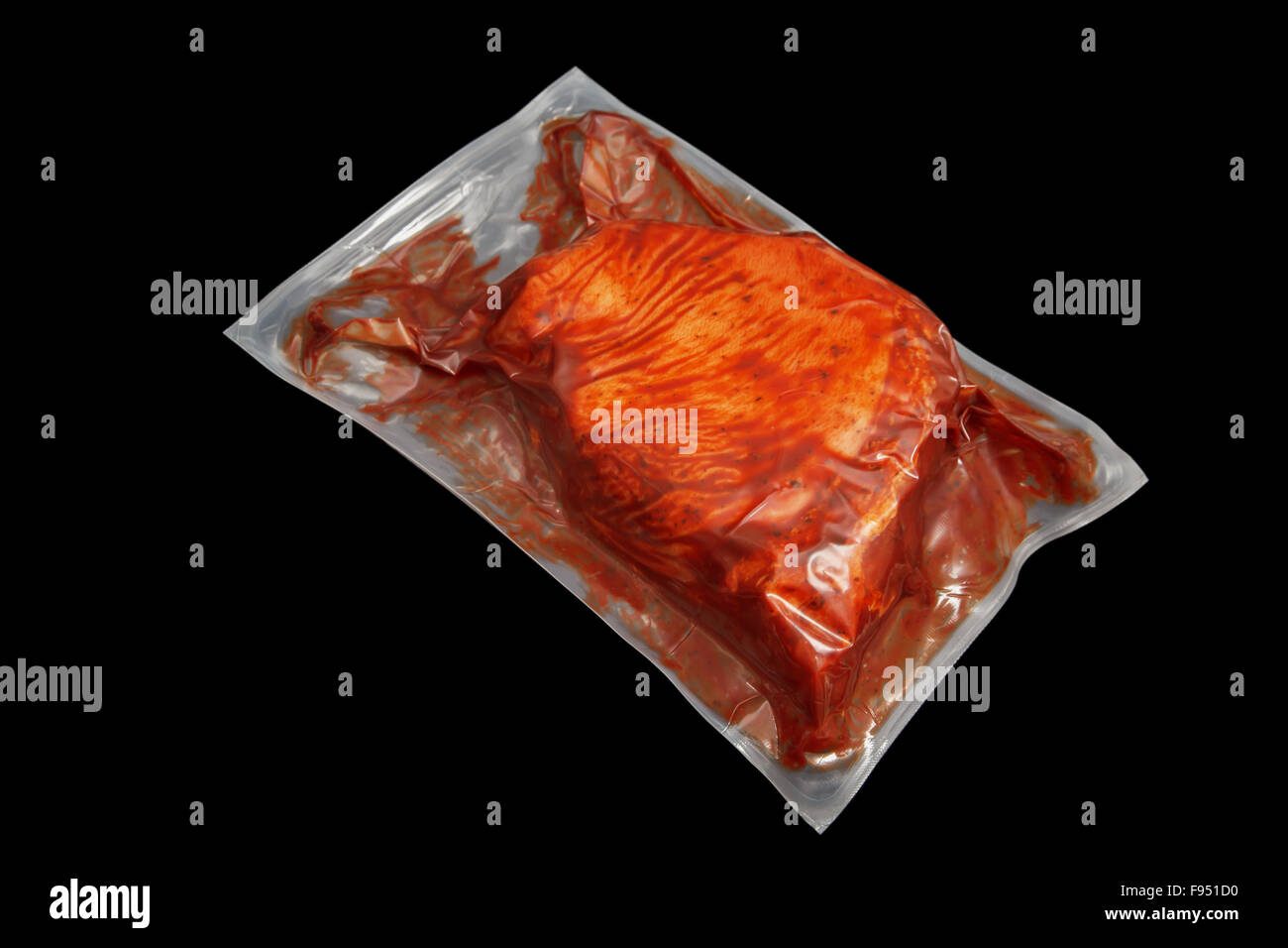 meat in a vacuum-sealed cooking bag on the black background Stock Photo -  Alamy
