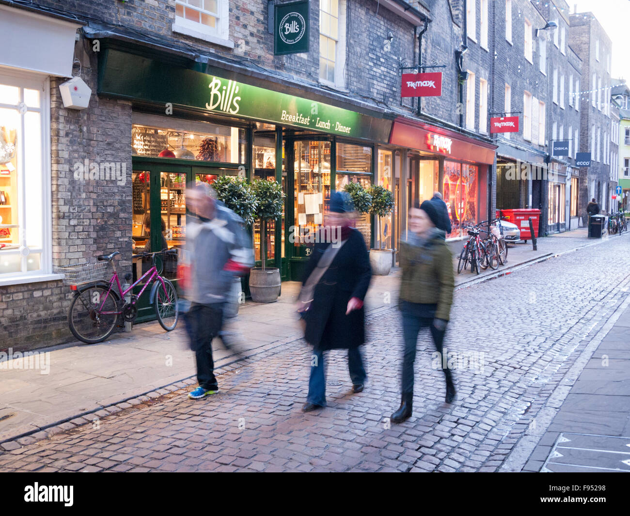 Shoppers walking in Green Street Canbridge UK in winter. Walking past Bill's restaurant Stock Photo