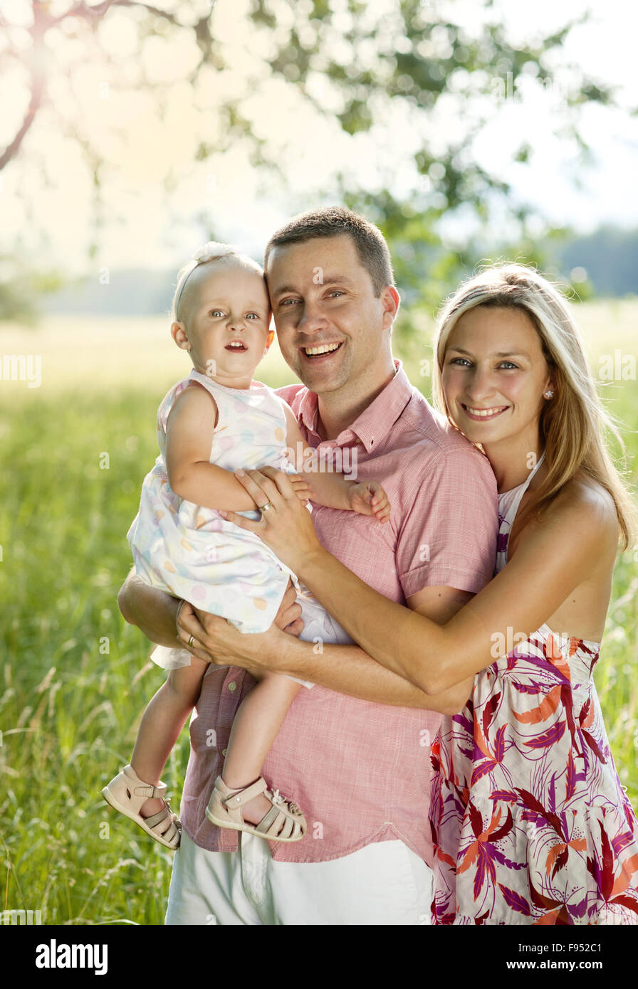 Happy young family spending time outdoor on a summer day Stock Photo