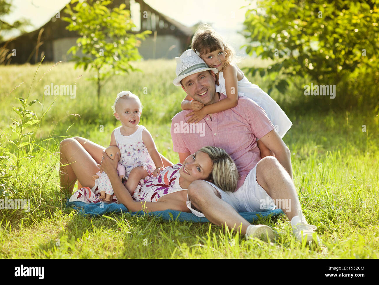 Happy young family spending time outdoor on a summer day Stock Photo