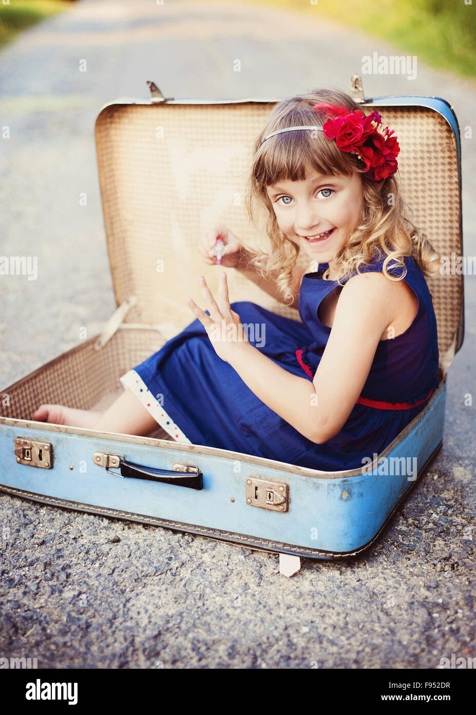 Cute little girl is having fun in the old suitcase Stock Photo