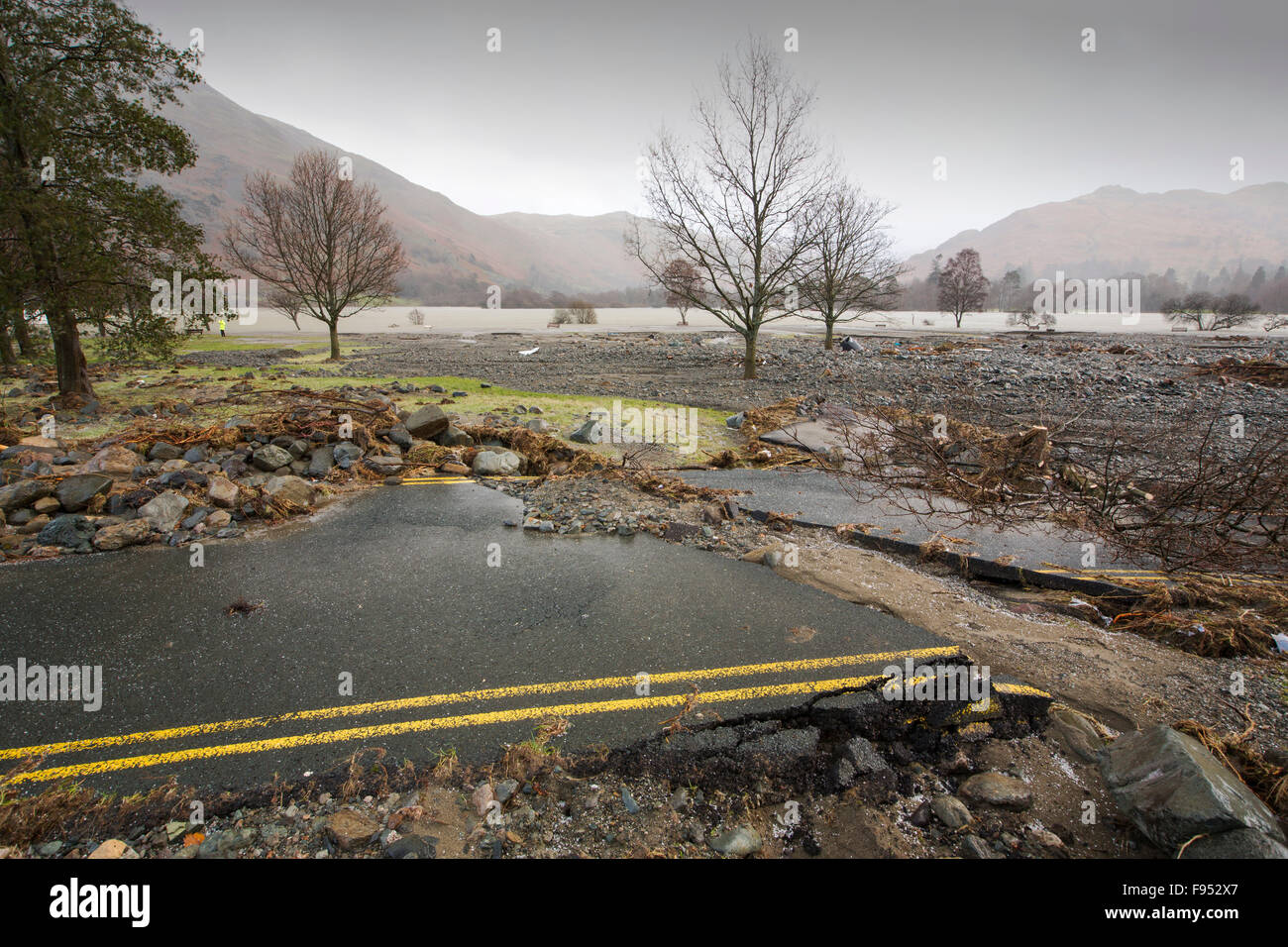 On Saturday 5th December 2015, Storm Desmond crashed into the UK, producing the UK's highest ever 24 hour rainfall total at 341.4mm. It flooded the Lakeland village Glenridding, which was just starting to repair when another period of heavy rain on Wednesday 9th December caused the Glenridding Beck to burst its banks, causing yet further destruction. This shot taken on Friday 11th December shows a road in Glenridding washed sideways by the force of the floods. Stock Photo