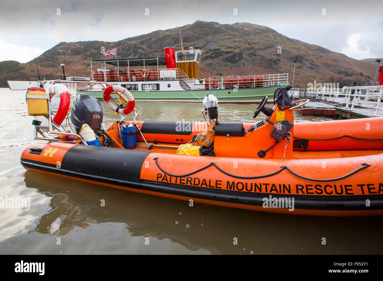 On Saturday 5th December 2015, Storm desmond crashed into the UK, producing the UK's highest ever 24 hour rainfall total at 341.4mm. It flooded the Lakeland village Glenridding, which was just starting to repair when another period of heavy rain on Wednesday 9th December caused the Glenridding Beck to burst its banks, causing yet further destruction. This photo taken the next morning on Friday 11th December shows Patterdale Mountain Rescue Team launching their rescue boat, to take food supplies to Howtown on the other side of the Lake that has been cut off for five days by the floods. Stock Photo