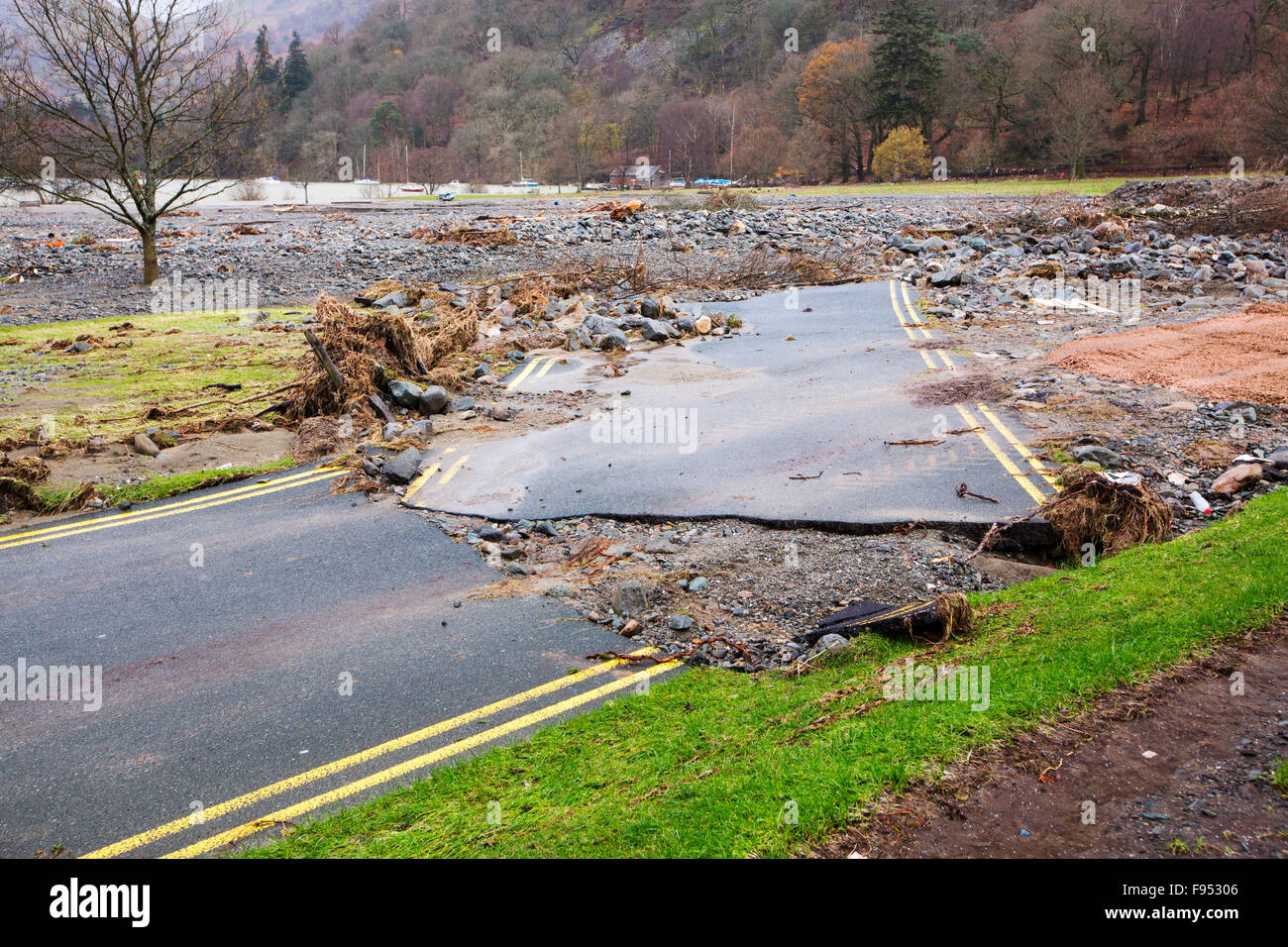 On Saturday 5th December 2015, Storm Desmond crashed into the UK, producing the UK's highest ever 24 hour rainfall total at 341.4mm. It flooded the Lakeland village Glenridding, which was just starting to repair when another period of heavy rain on Wednesday 9th December caused the Glenridding Beck to burst its banks, causing yet further destruction. This shot taken on Friday 11th December shows a road in Glenridding washed sideways by the force of the floods. Stock Photo