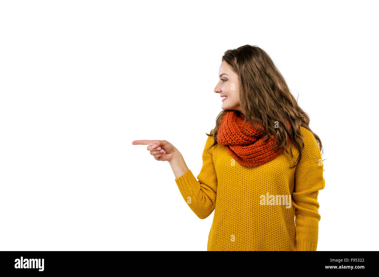 Portrait of beautiful girl in autumn clothes showing a product - empty copy space showing with her fingers, isolated on white ba Stock Photo