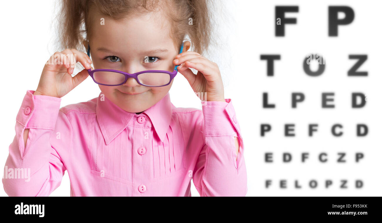 Funny kid putting on spectacles in ophthalmologist office Stock Photo