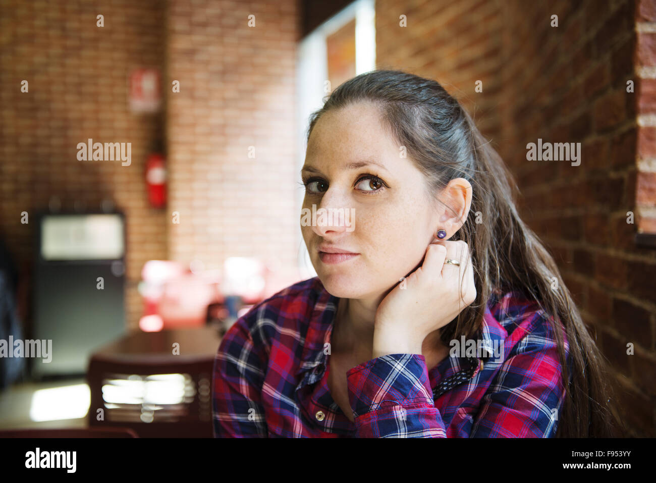 Pretty young woman sitting in the cafe Stock Photo