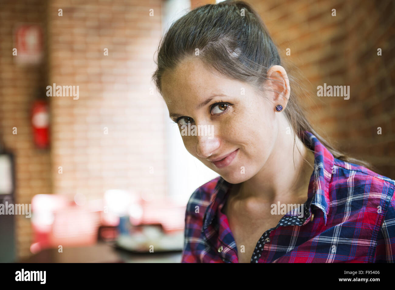 Pretty young woman sitting in the cafe Stock Photo