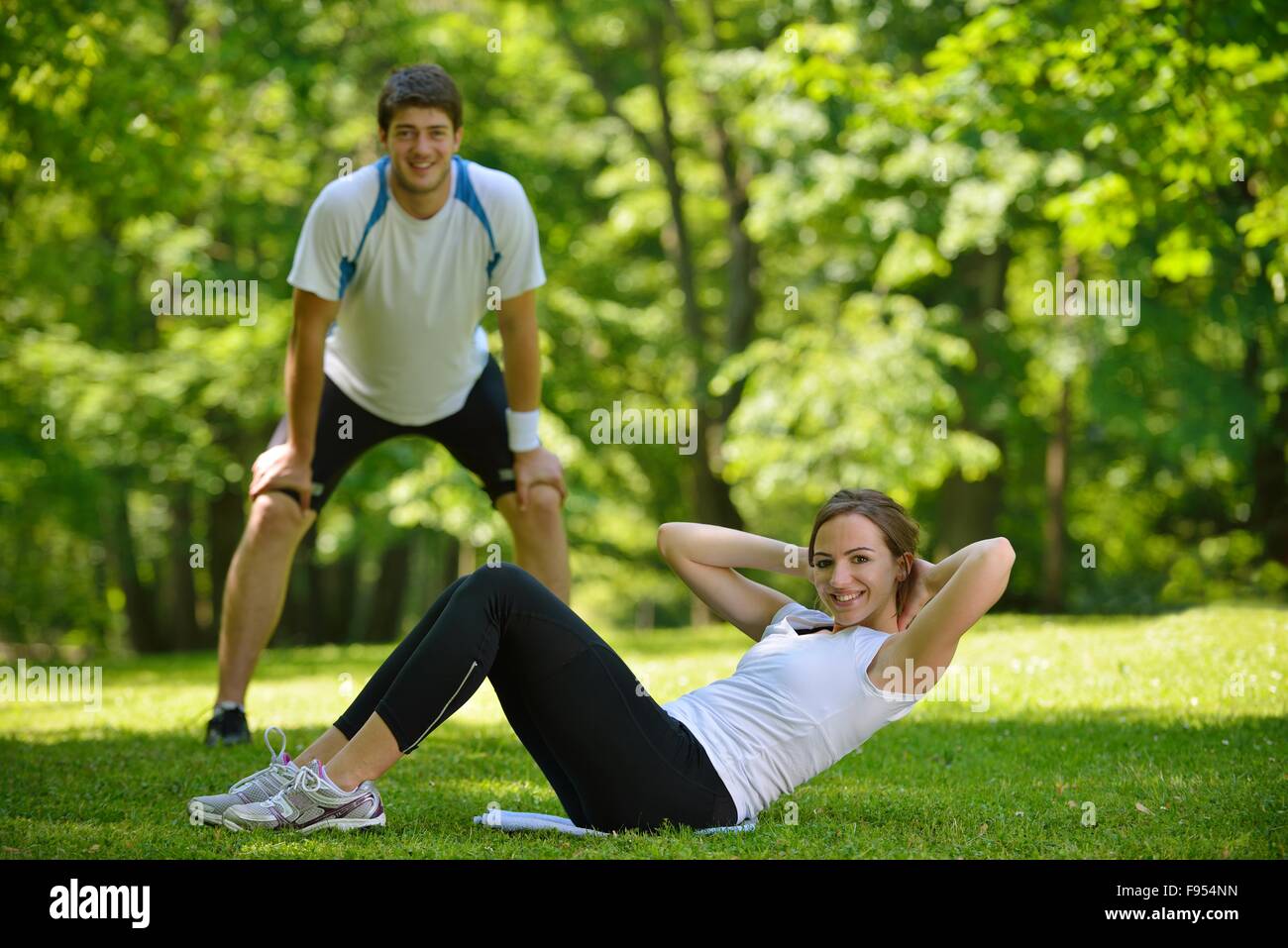 young health couple doing stretching exercise relaxing and warm up