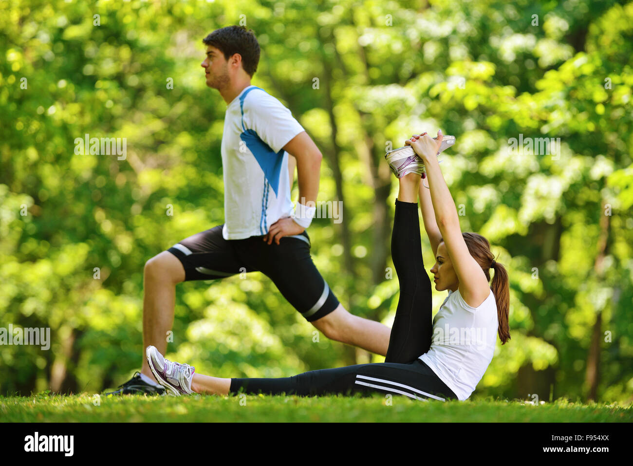 young health couple doing stretching exercise relaxing and warm up