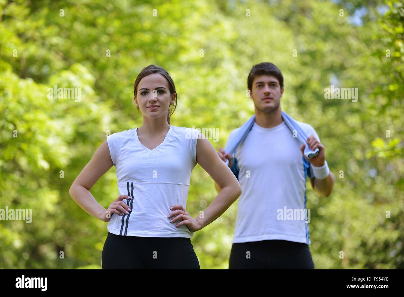 young health couple doing stretching exercise relaxing and warm up