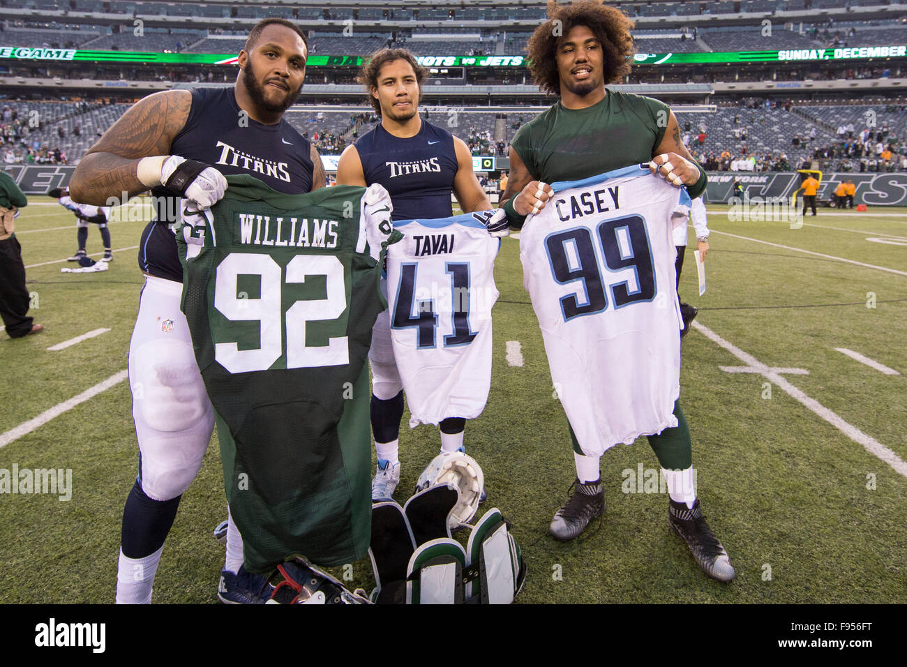 December 13, 2015, New York Jets defensive end Muhammad Wilkerson (96) and  Tennessee Titans defensive end Jurrell Casey (99) exchange jerseys with  linebacker J.R. Tavai (41) by them during the NFL game