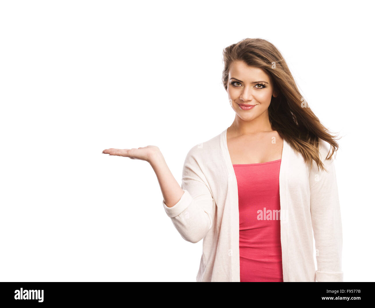 Happy young woman showing a product - empty copy space on the open hand ...