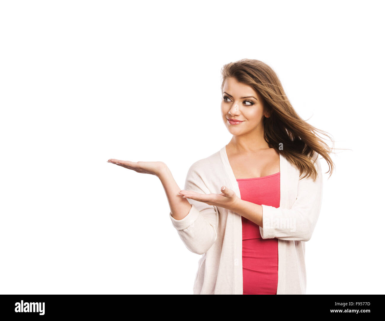 Happy young woman showing a product - empty copy space on the open hand ...