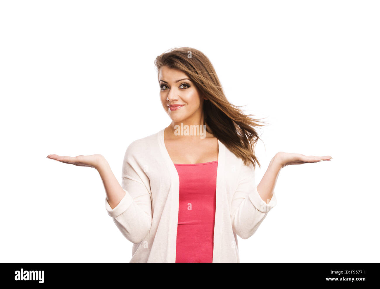 Happy young woman showing a product - empty copy space on the open hand ...