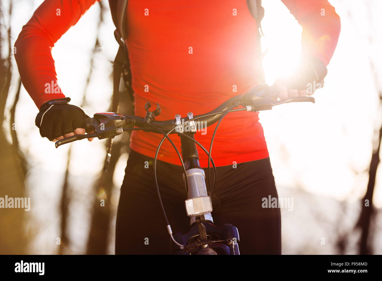 Closeup of cyclist man legs riding mountain bike on outdoor trail in autumn forest Stock Photo