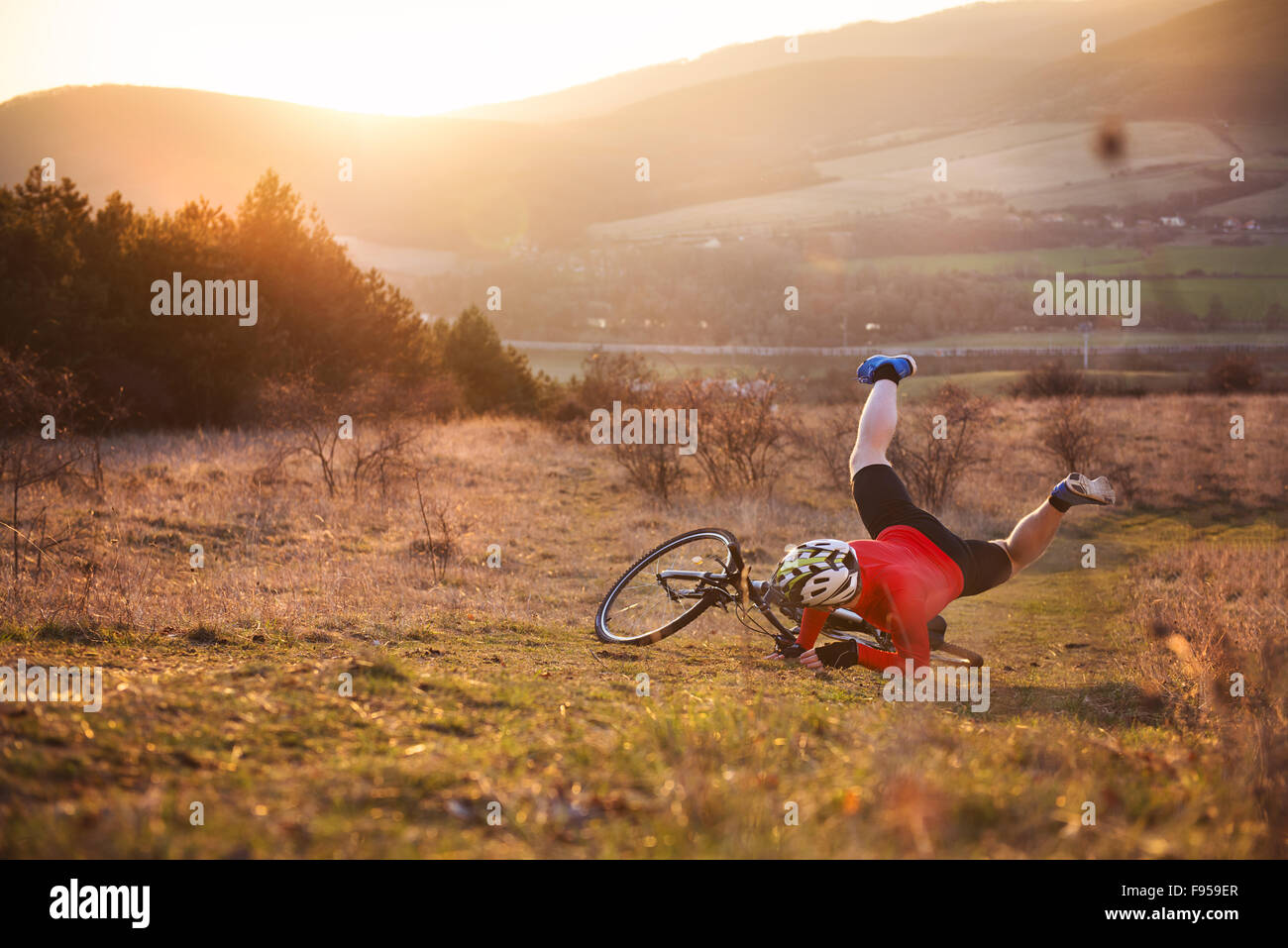 Mountain Biker has a painful looking crash with his bike Stock Photo