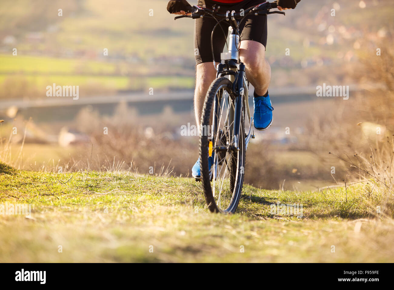 Detial of cyclist man legs riding mountain bike on outdoor trail in nature Stock Photo