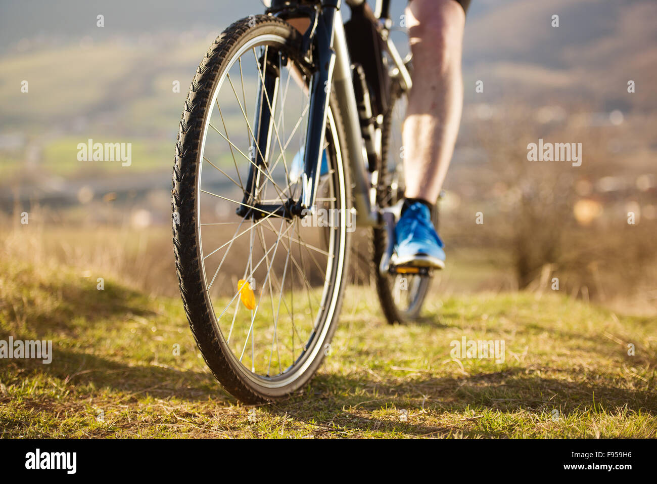 Closeup of cyclist man legs riding mountain bike on outdoor trail in nature Stock Photo